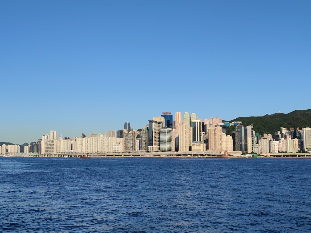 city skyline across body of water during daytime