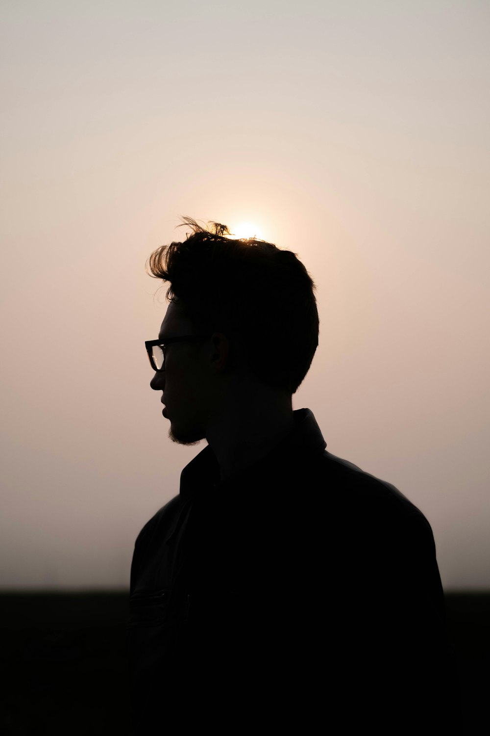 man in black collared shirt wearing black framed eyeglasses