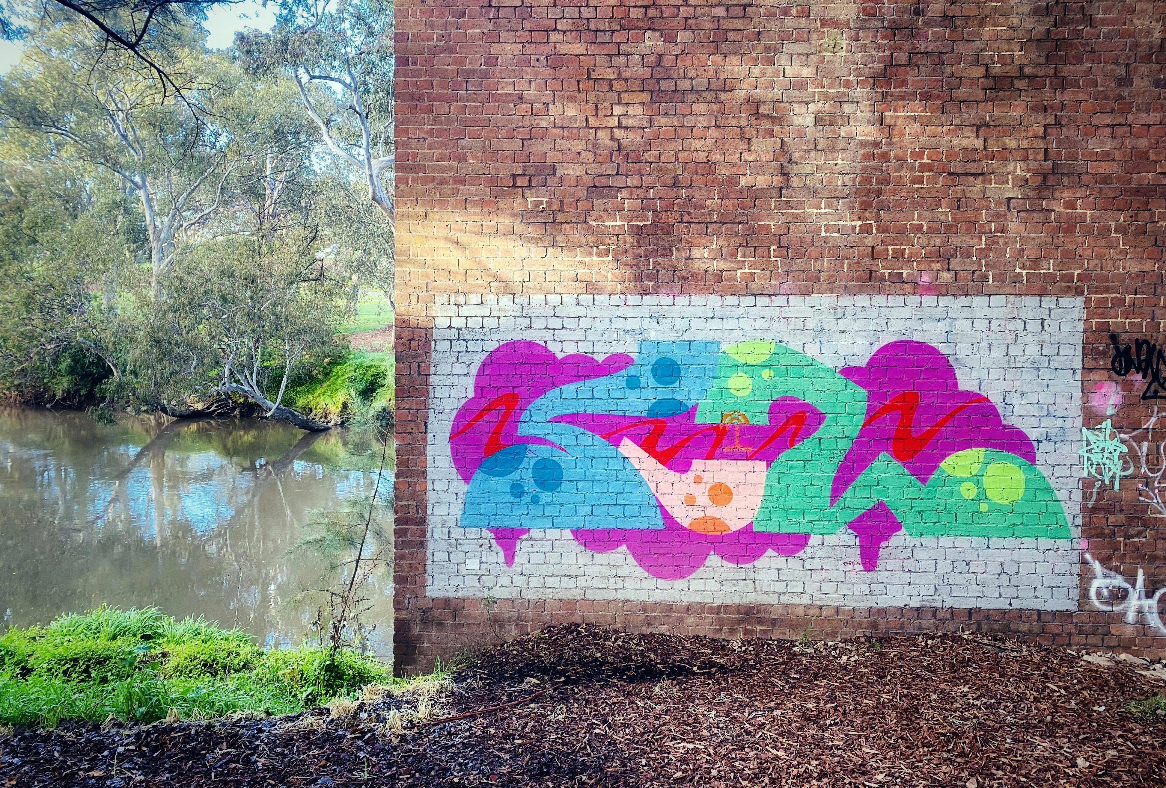 brown brick wall with graffiti