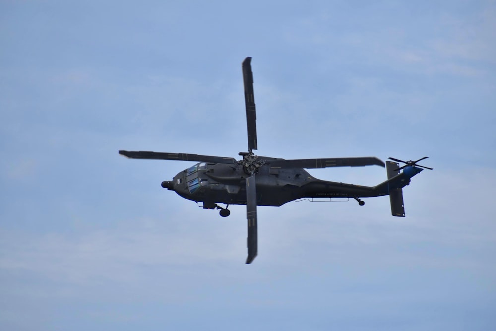 black fighter plane in mid air during daytime