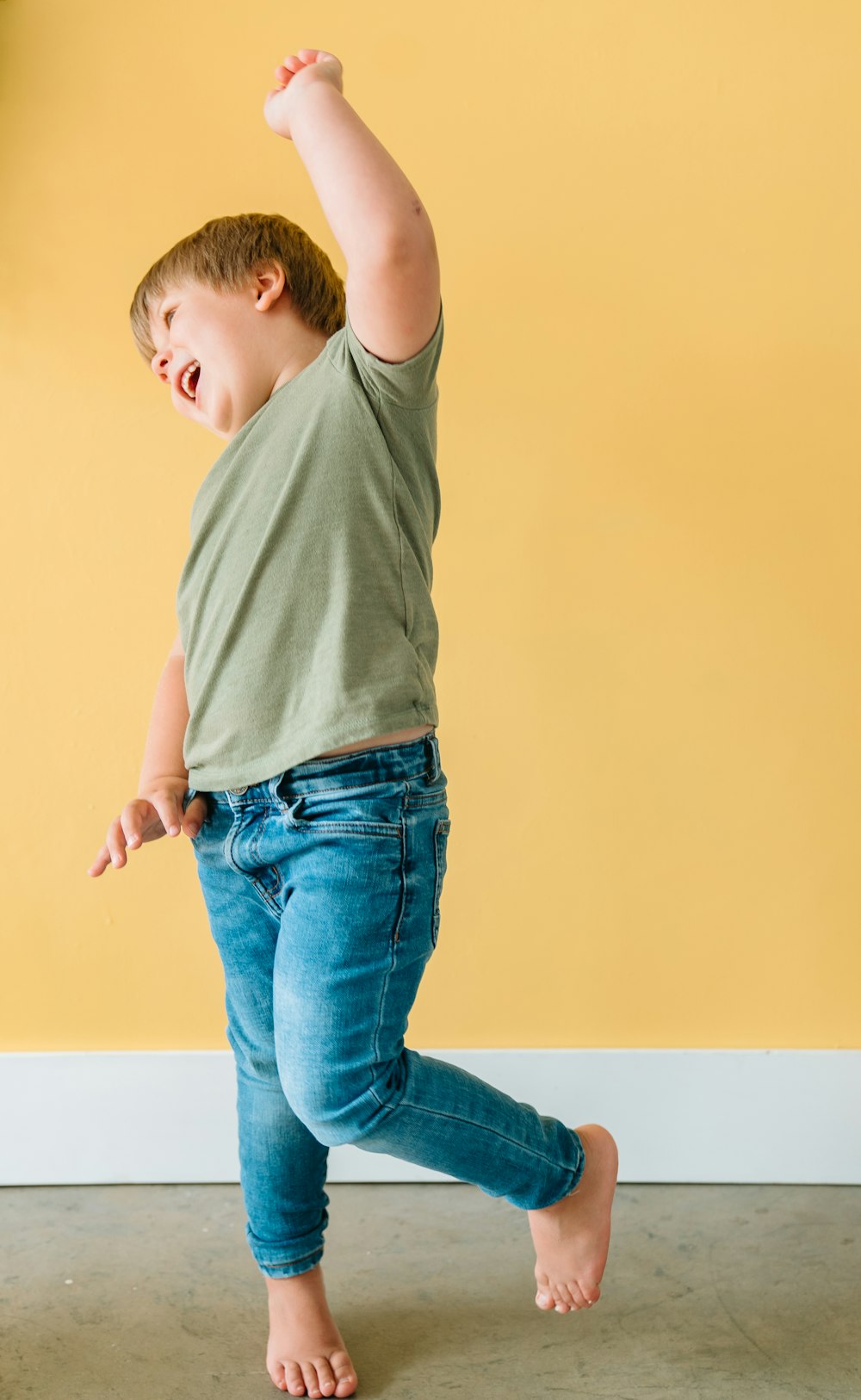 boy in gray t-shirt and blue denim jeans