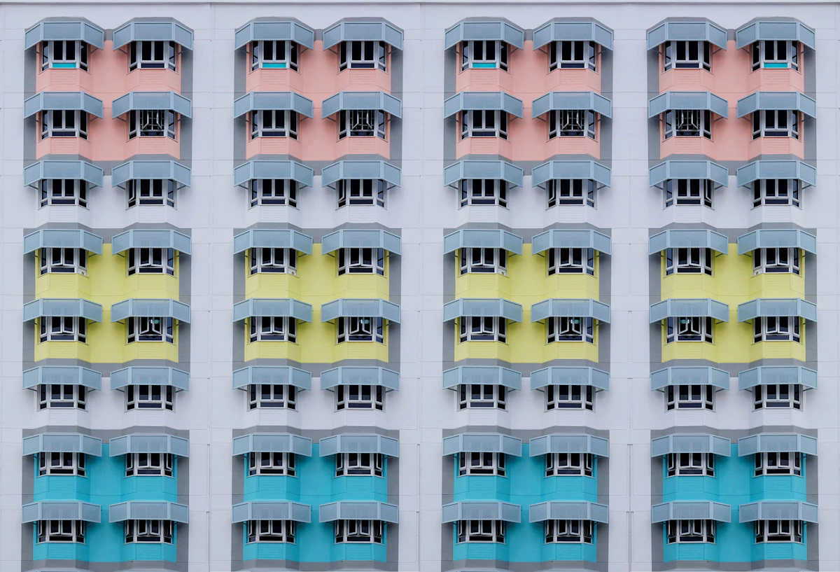 A facade of identical windows in pastel colours