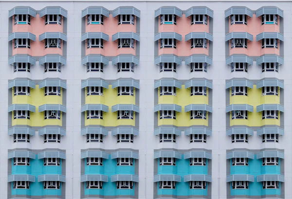 A facade of identical windows in pastel colours