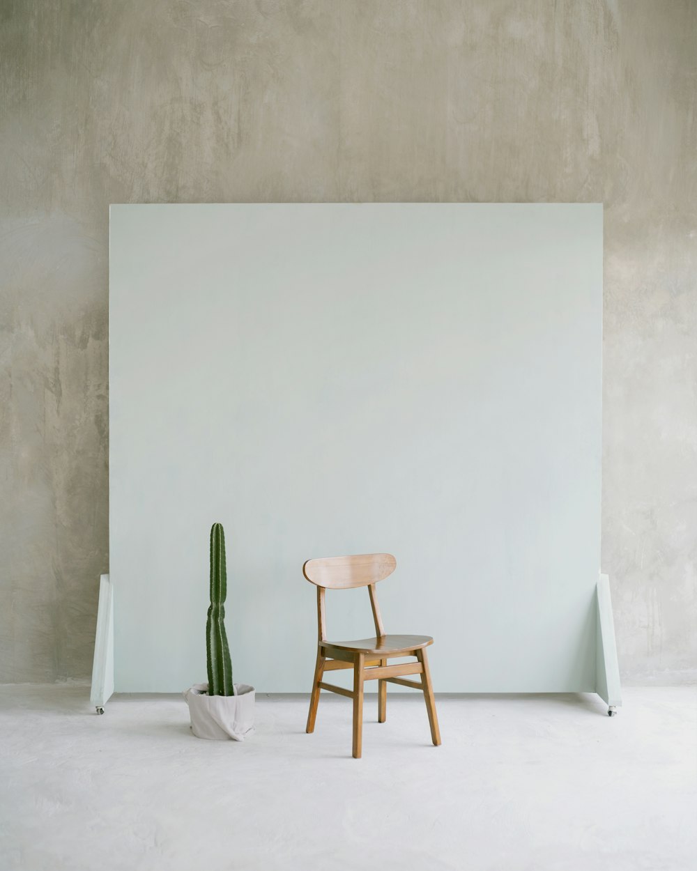 brown wooden seat beside white wall