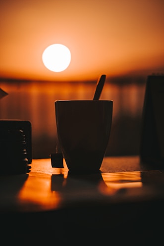 black ceramic mug on brown wooden table