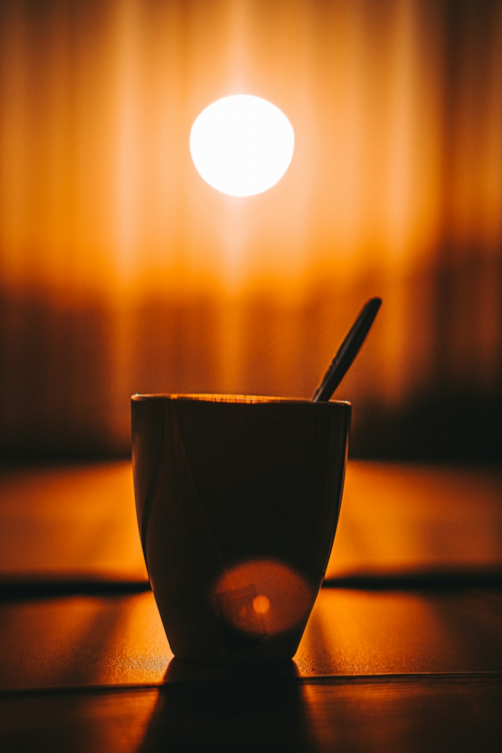 black ceramic cup with stainless steel spoon