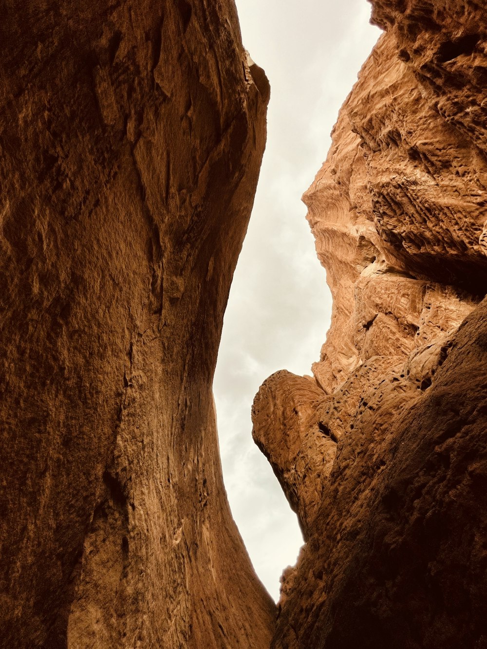 brown rock formation under white clouds during daytime