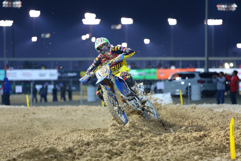 man in green and black motorcycle suit riding motocross dirt bike