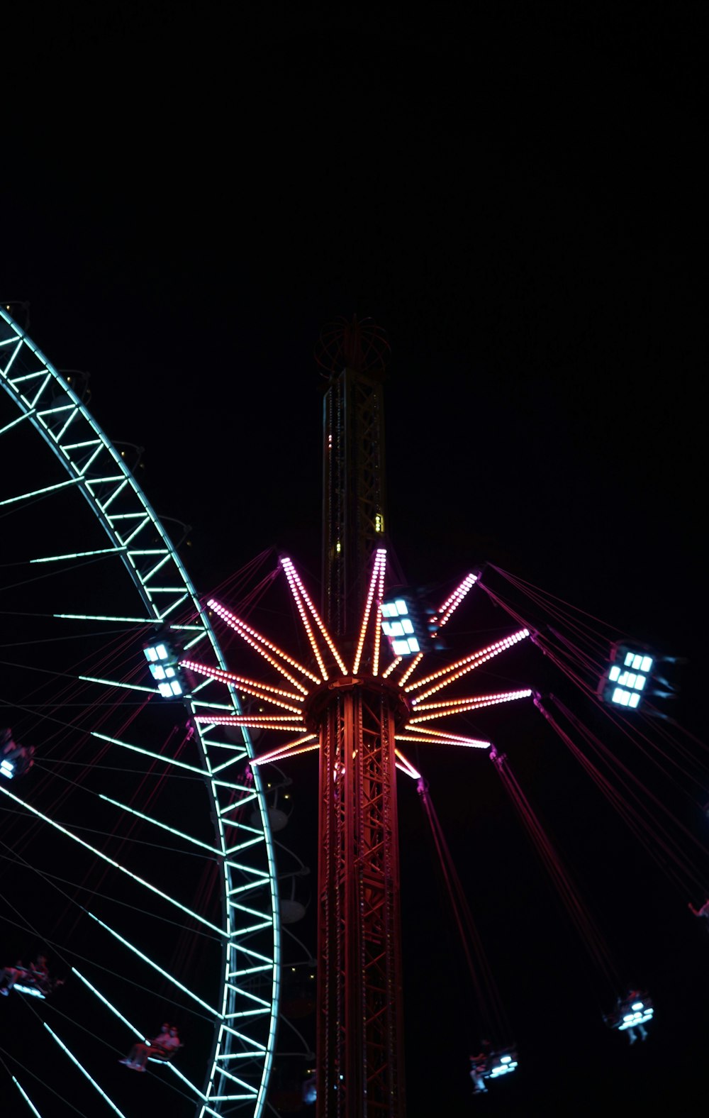 red and black ferris wheel during night time