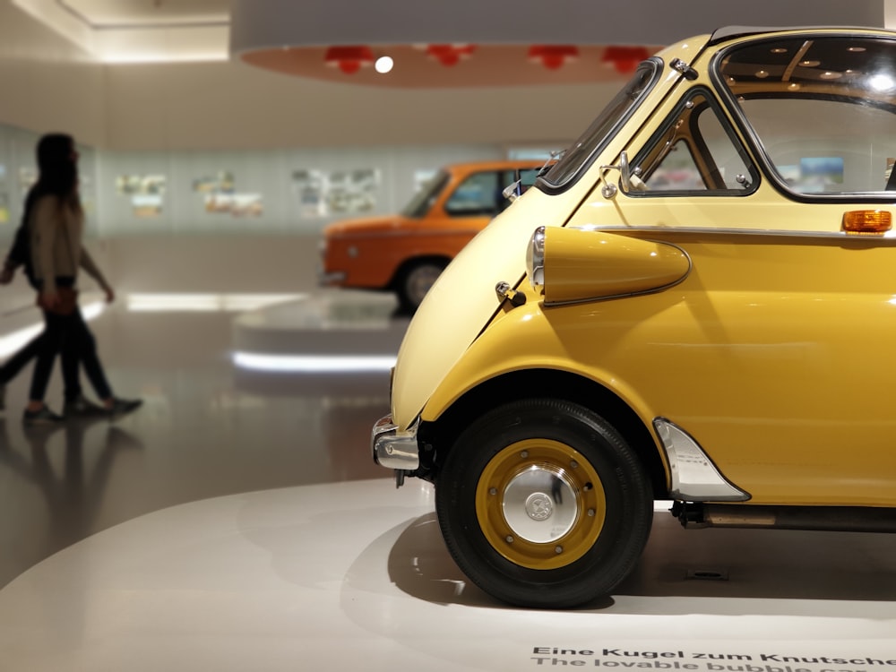 yellow volkswagen beetle on road during daytime