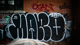 Dark charcoal wall with a single, punchy tagline painted in white, raw and unapologetic.