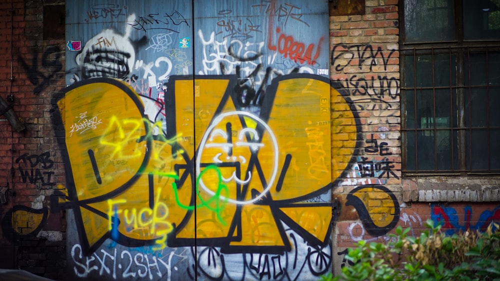 graffiti on brick wall during daytime