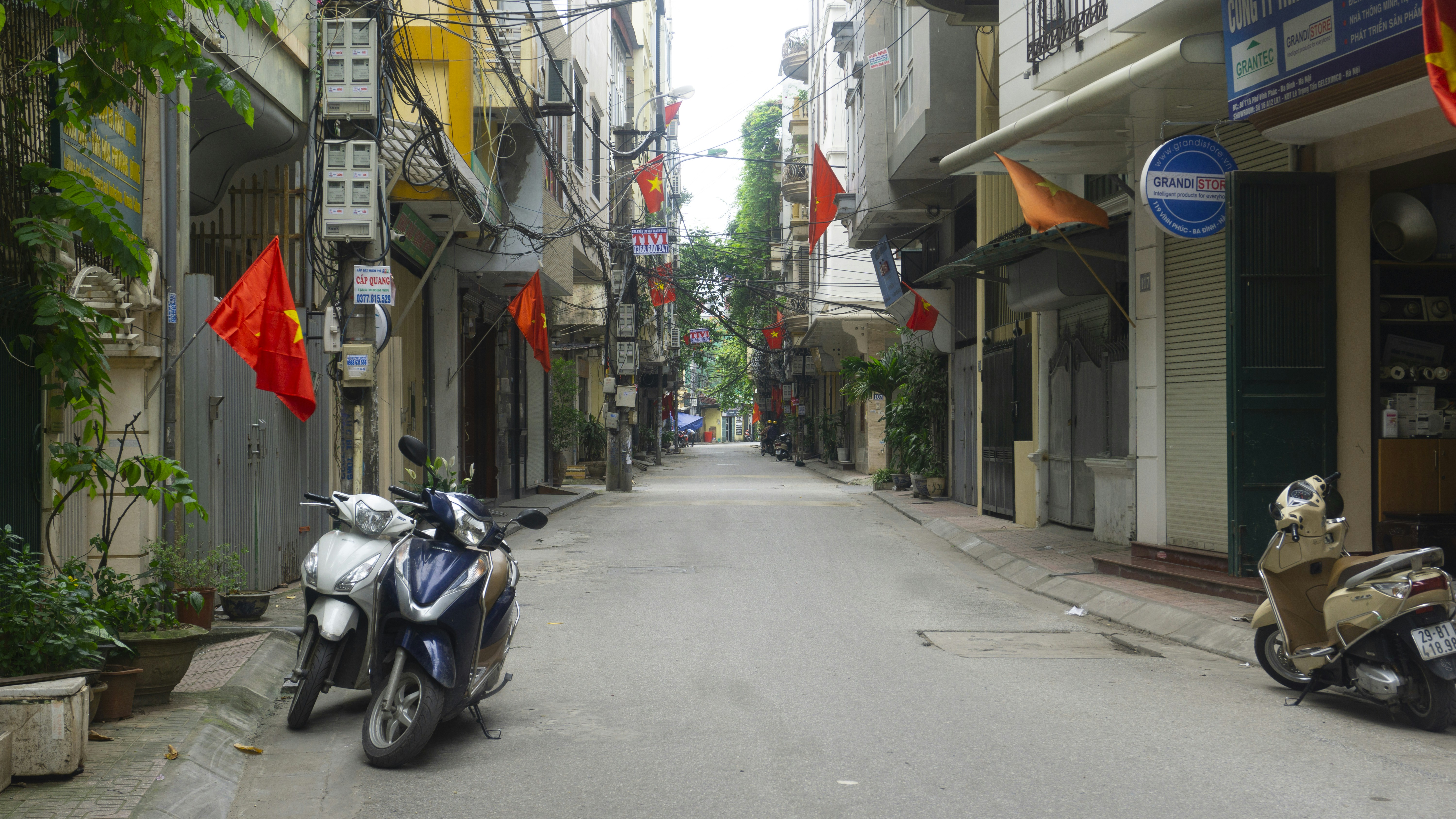 black motorcycle parked on sidewalk during daytime