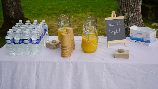 clear glass bottle with gold lid on white textile