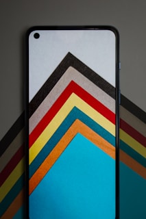 Screenshot of a colorful puzzle game with vibrant shapes and smooth animations on an Android phone.