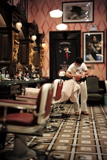 man in white t-shirt sitting on barber chair
