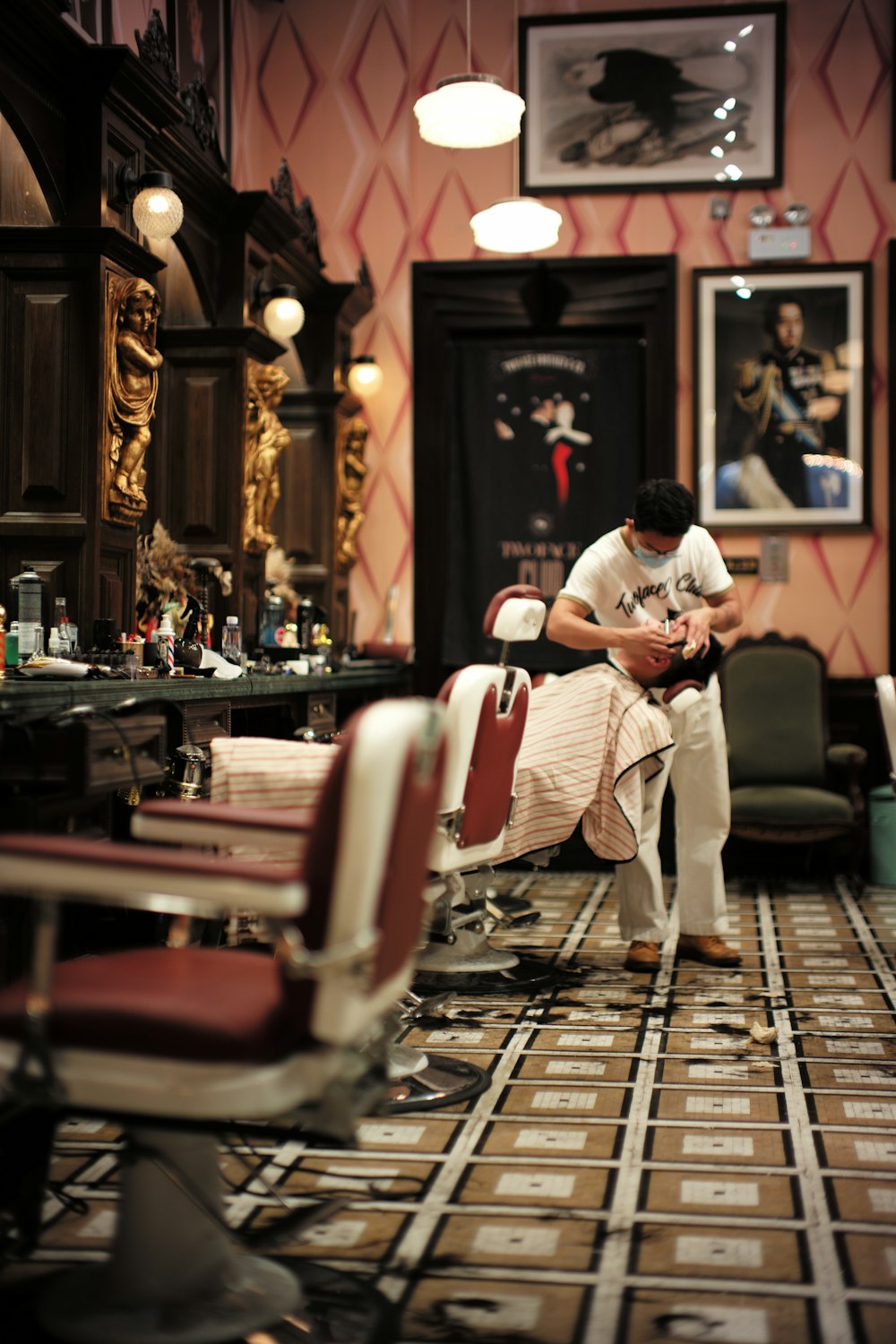 man in white t-shirt sitting on barber chair