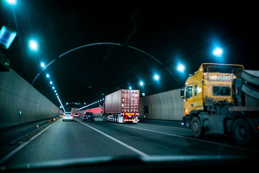 yellow truck on road during nighttime