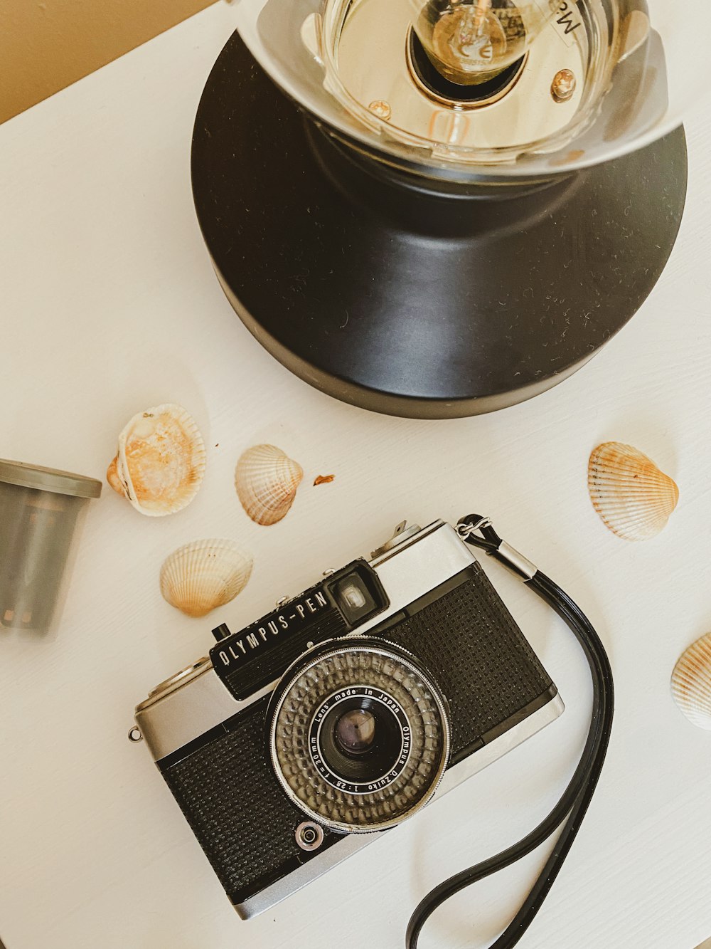 black and silver camera on white table