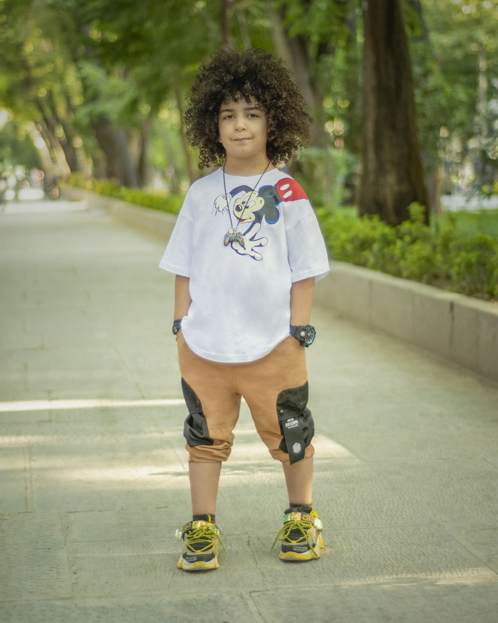 woman in white crew neck t-shirt and blue denim shorts standing on gray concrete road