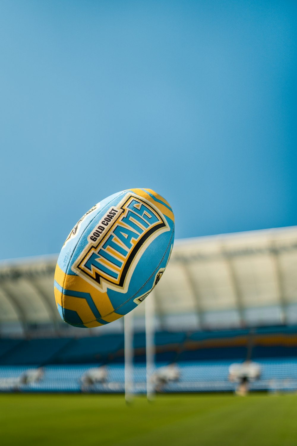 yellow and blue volleyball on white metal fence during daytime