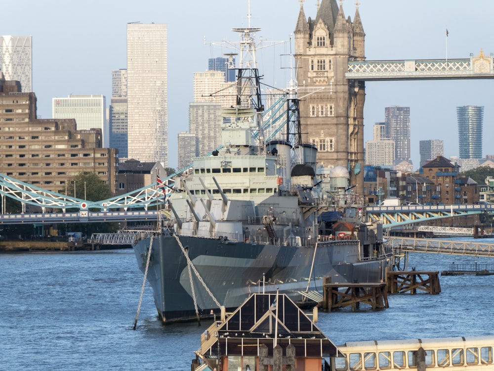 white and brown ship on sea near city buildings during daytime