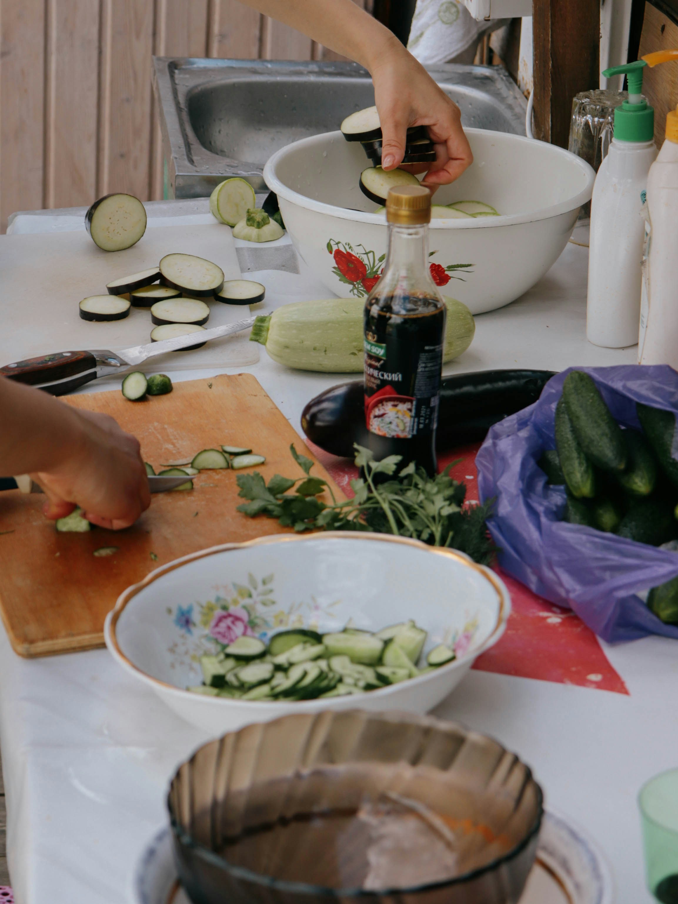 Person using a nakiri knife to cut vegetables with precision