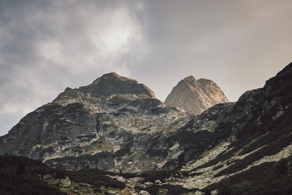 montagne grise et blanche sous ciel nuageux blanc pendant la journée