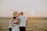 A happy family smiling in front of their pest-free home at sunset.