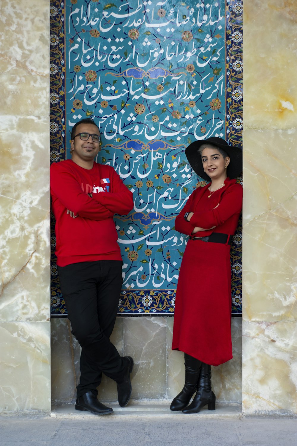 man in red long sleeve shirt standing beside woman in red long sleeve shirt