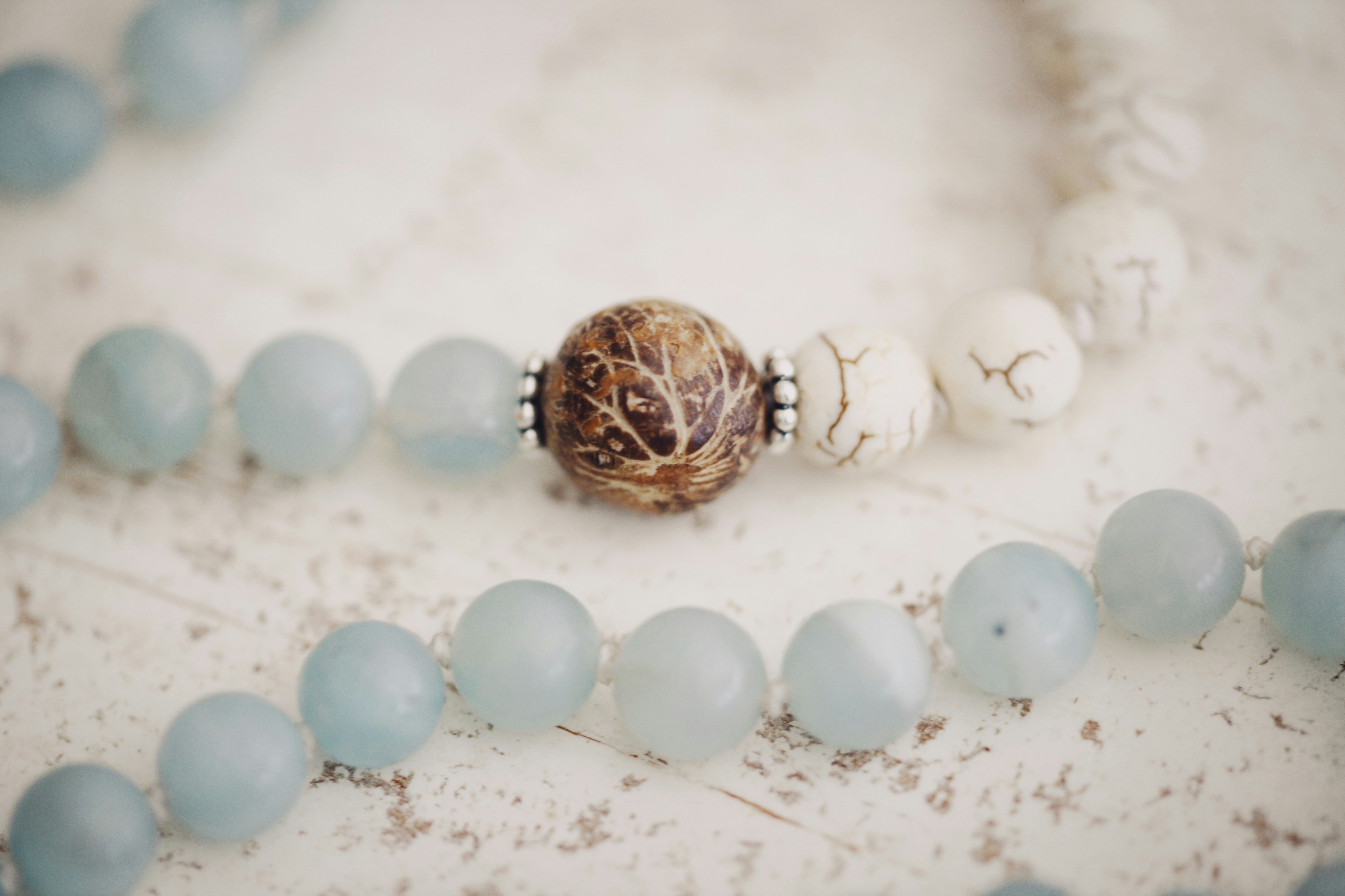 gold and white round ornament on white and brown pebbles