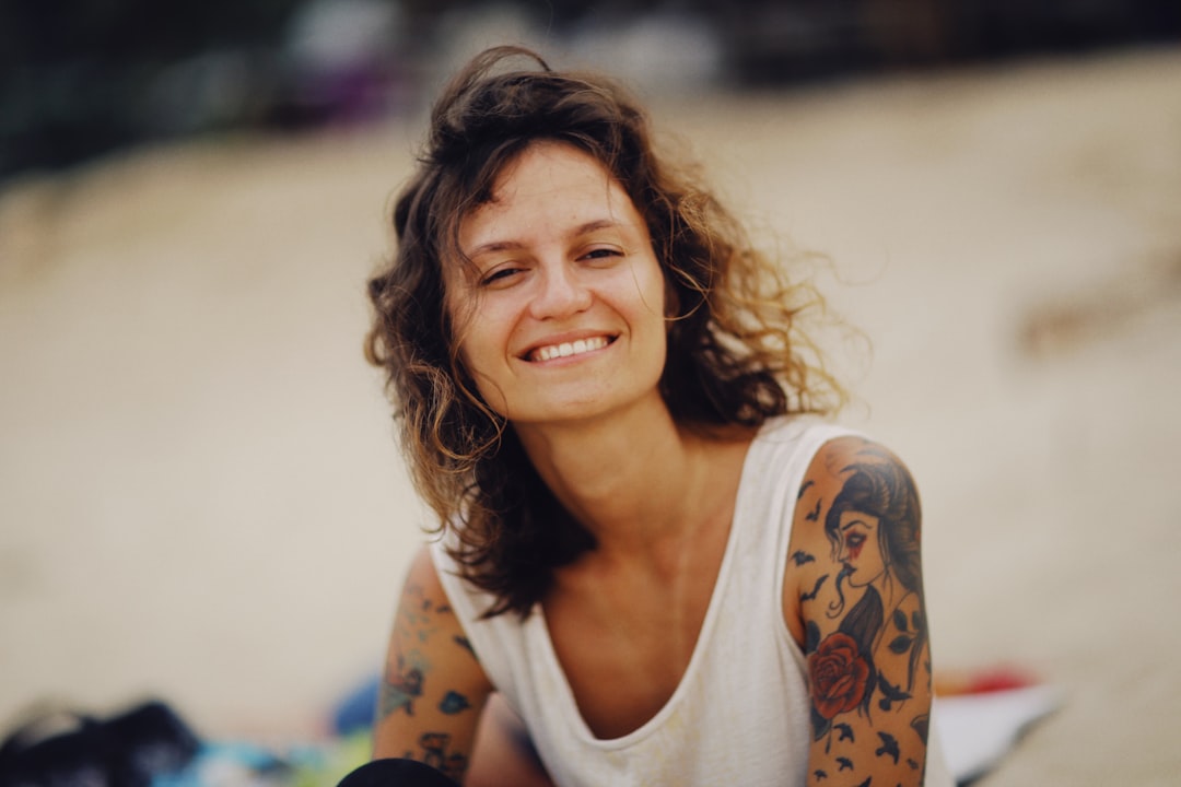 smiling woman in white tank top