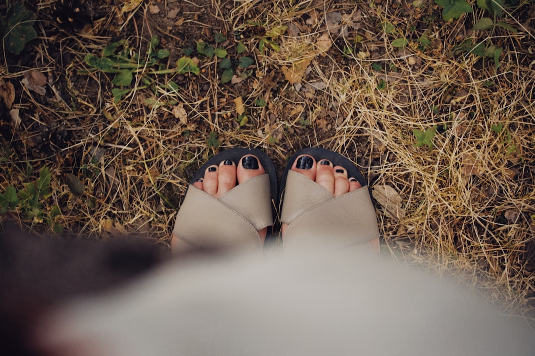 person wearing black flip flops