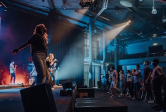 woman in black long sleeve shirt and black pants performing on stage