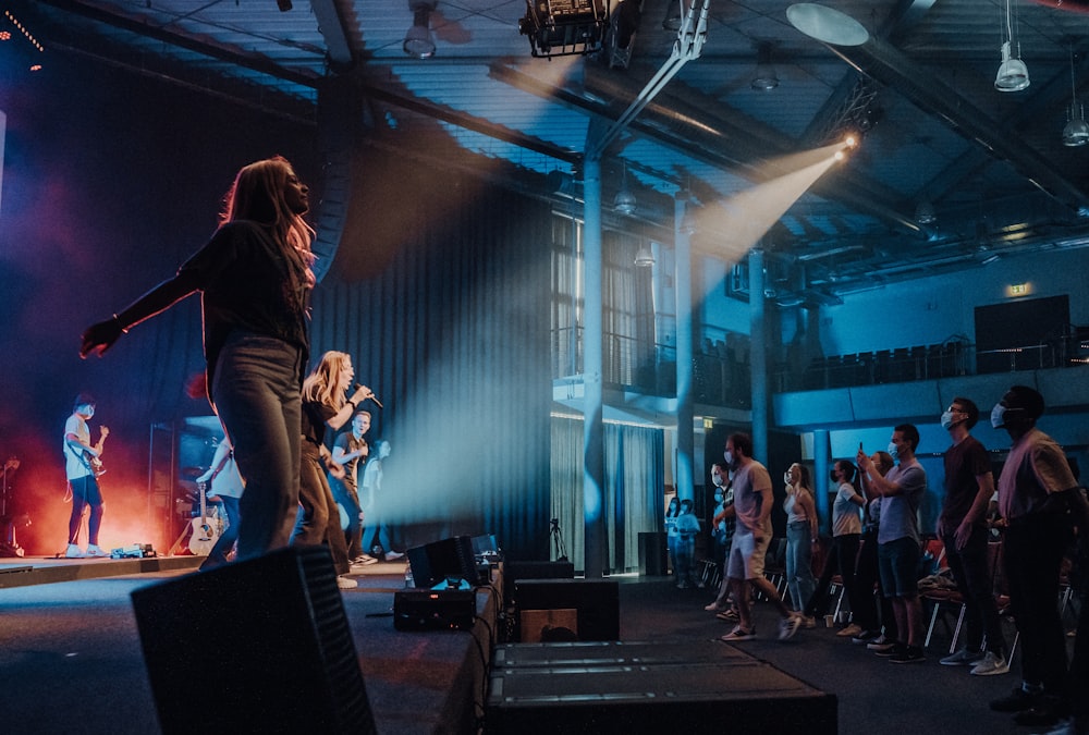 woman in black long sleeve shirt and black pants performing on stage