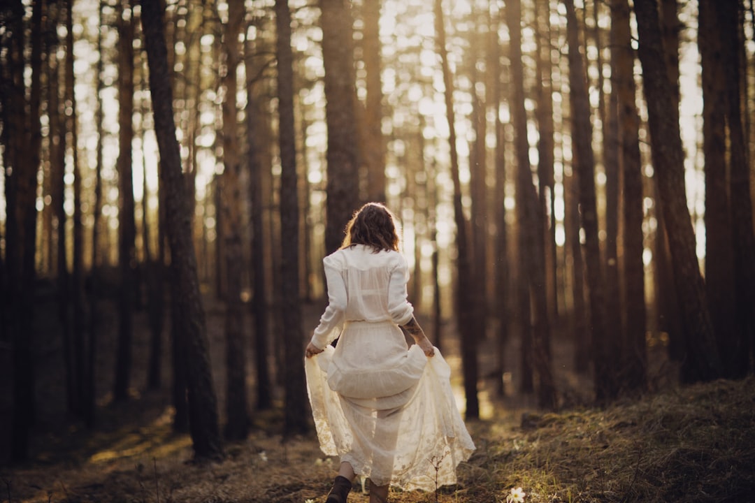 woman in white dress in forest during daytime