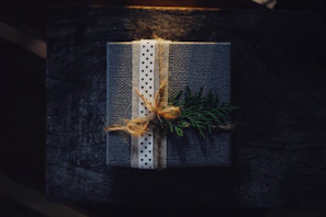 A cozy display of handcrafted gift boxes with delicate ribbons and natural elements.