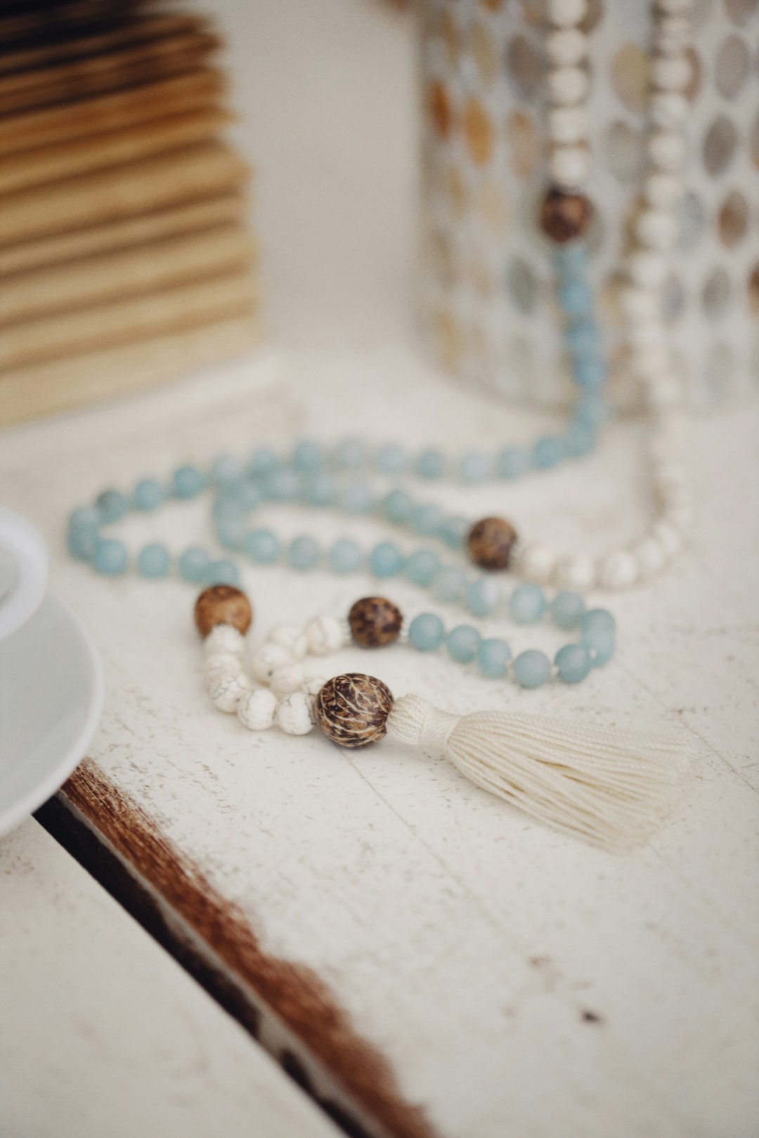 white pearl necklace on white textile