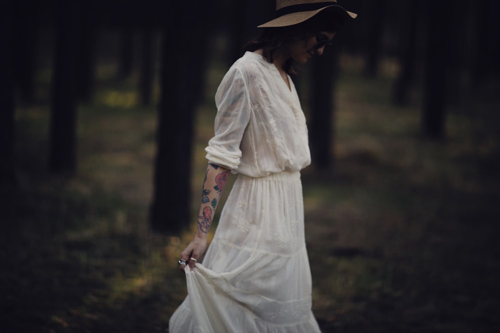 woman in white dress wearing brown hat