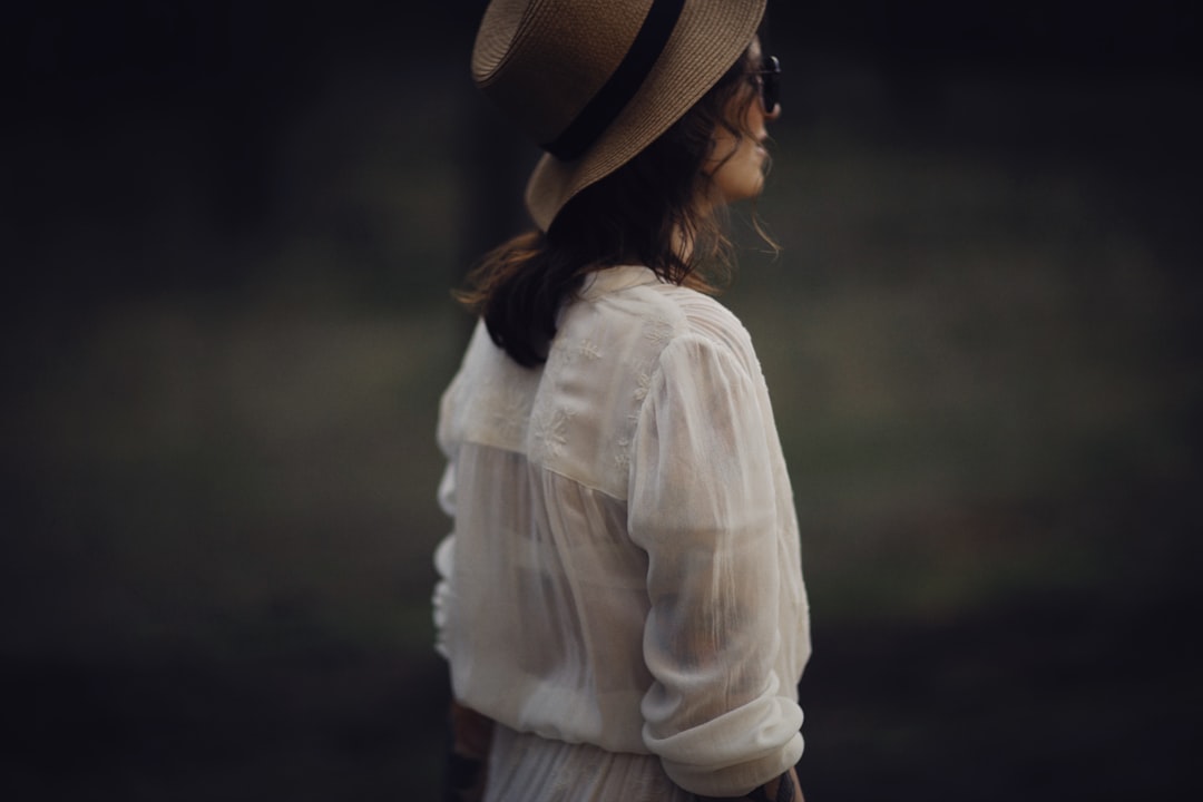 woman in white long sleeve shirt and brown fedora hat