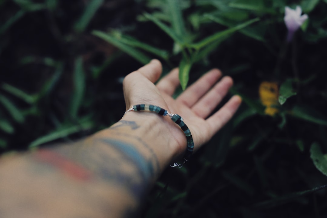 person wearing blue and white bracelet