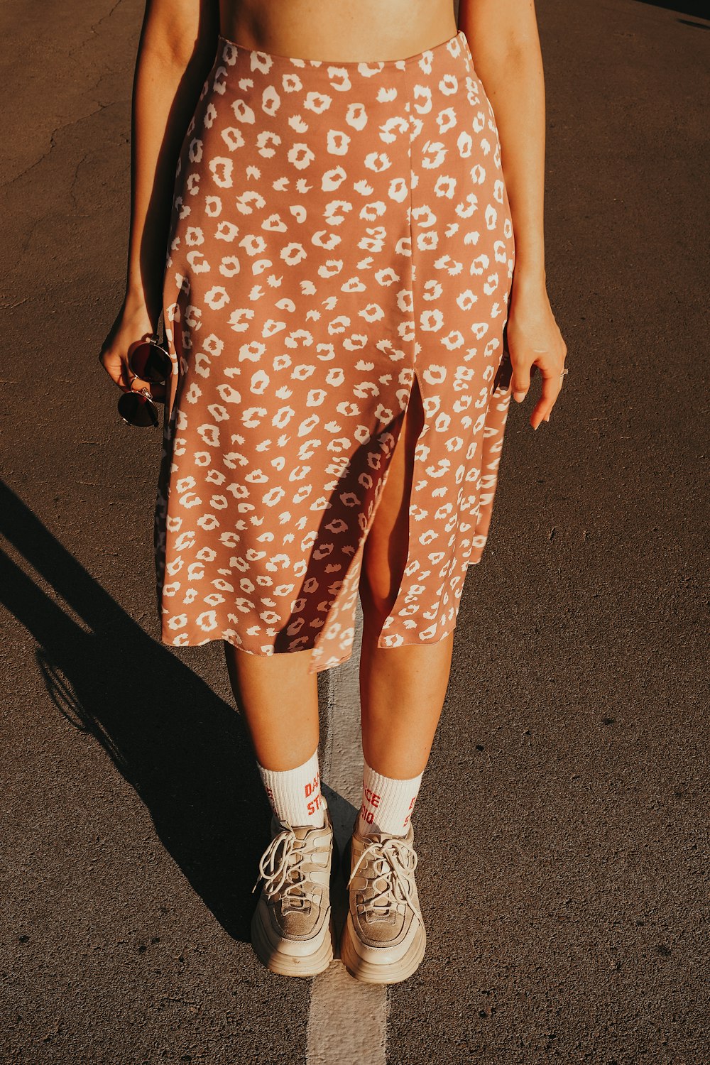 woman in orange and white polka dots dress