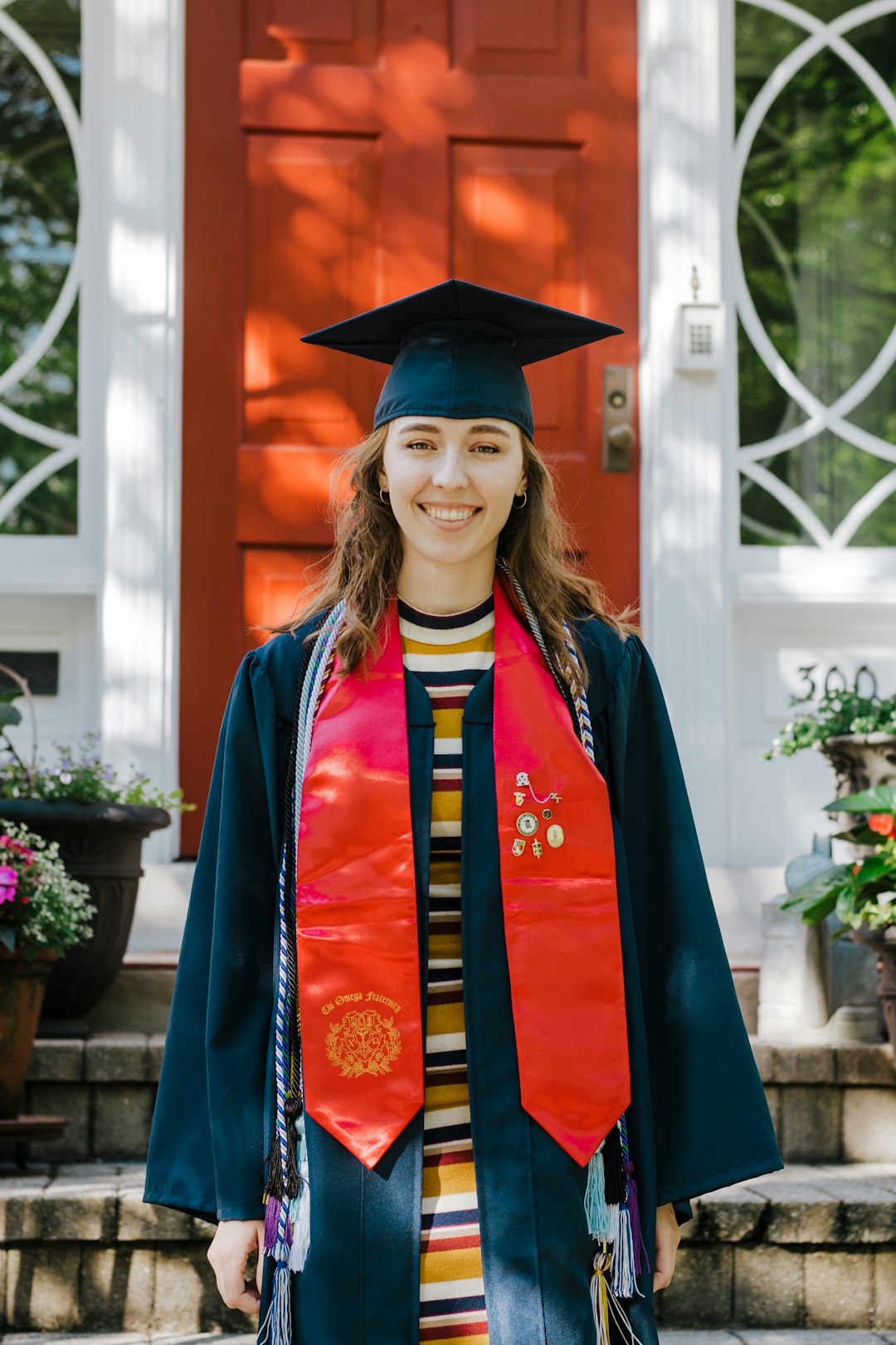 woman in blue academic dress wearing academic hat