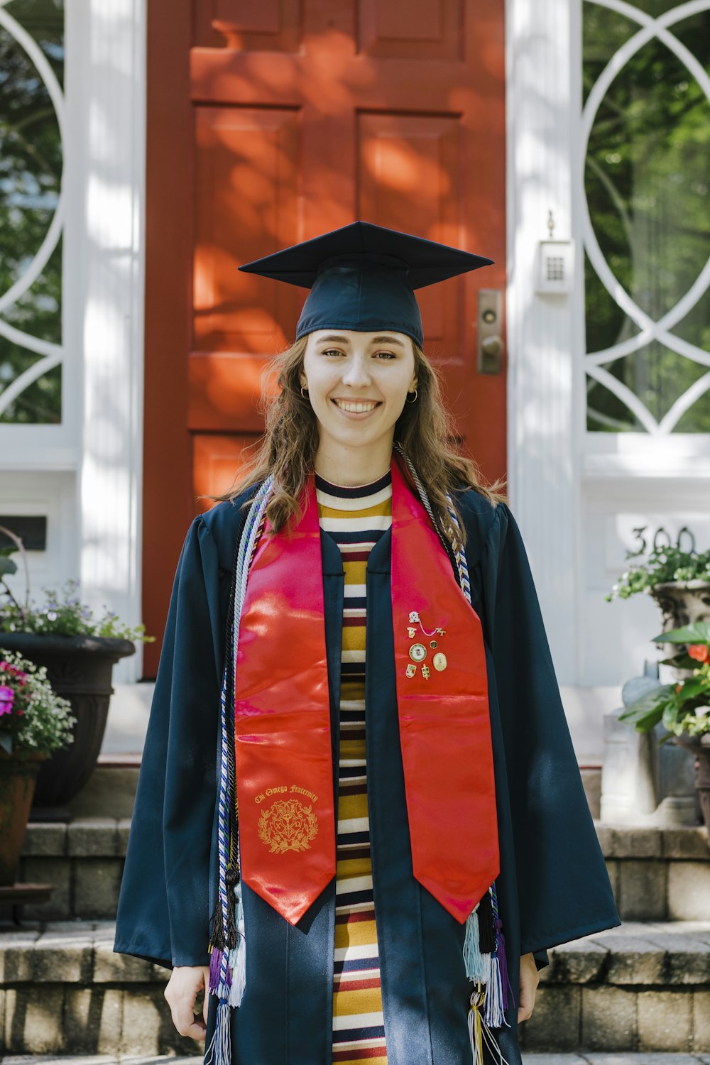 woman in blue academic dress wearing academic hat