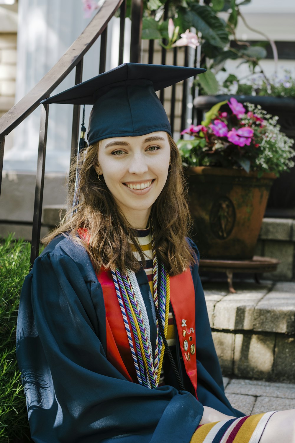 woman in red academic dress and black academic hat