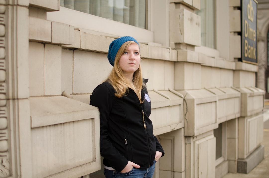 woman in black jacket and blue denim jeans