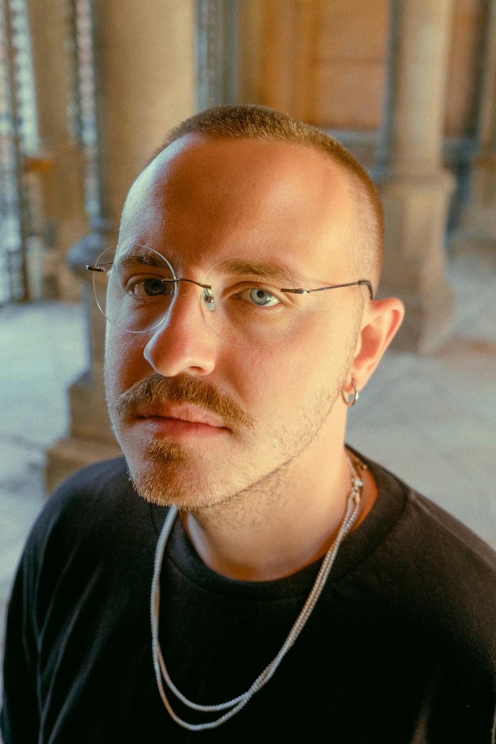 man in black crew neck shirt wearing eyeglasses