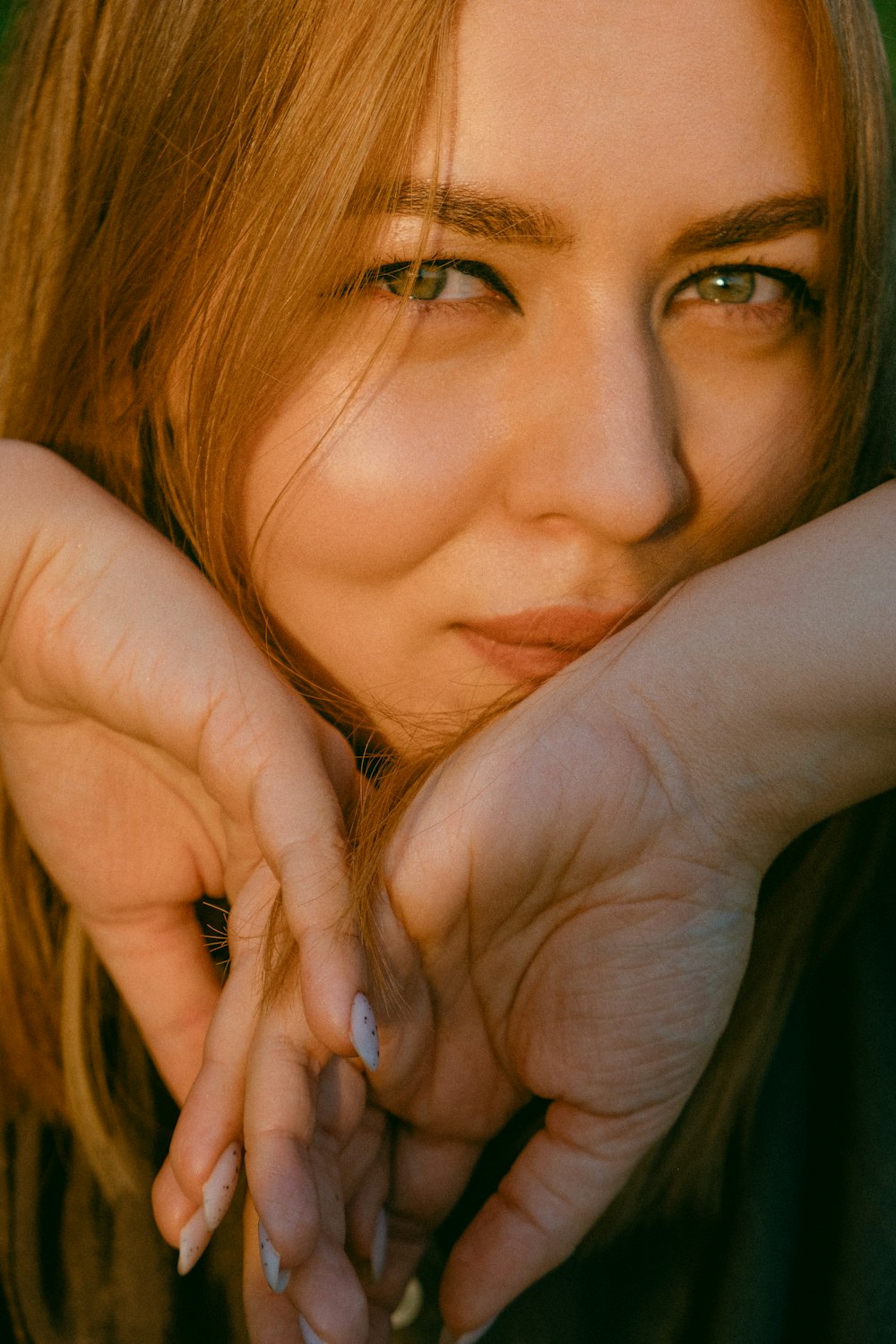 woman covering her face with her hand