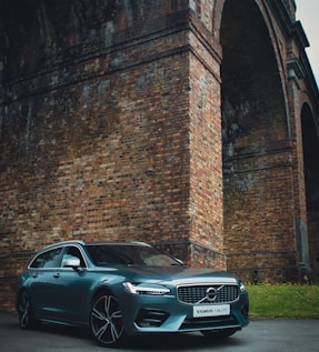 black mercedes benz coupe parked beside brick wall