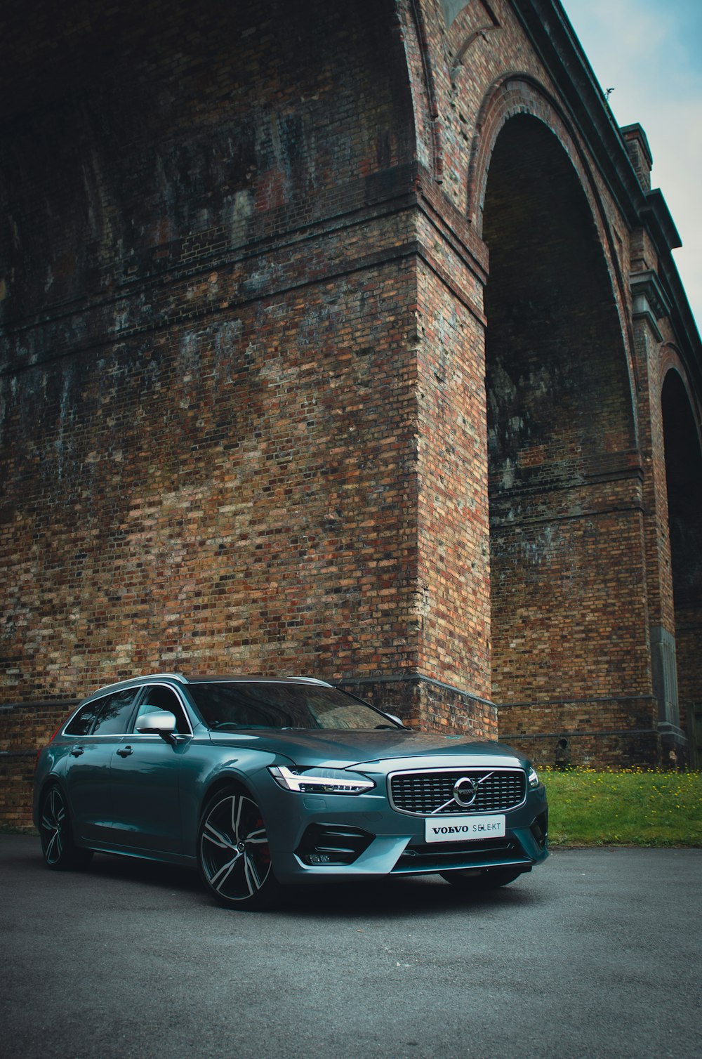 black mercedes benz coupe parked beside brick wall